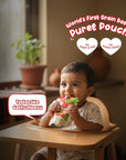 Baby eating Rorosaur Millet-y Pumpkin puree pouch made with pumpkin, lentils, oats, and cashew with no sugar or preservatives.