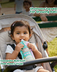Baby sipping Rorosaur Cucumber Basil puree outdoors showing wholesome ingredients and complete nutrition mothers trust.