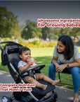 Baby drinking Rorosaur Millet-y Pumpkin puree in stroller with mother nearby, showing complete nutrition and wholesome ingredients.